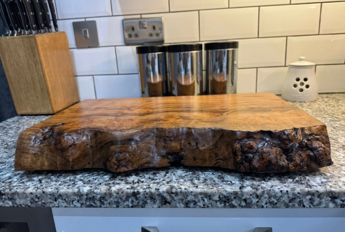A large piece of wood resting on a countertop, showcasing its natural texture and grain