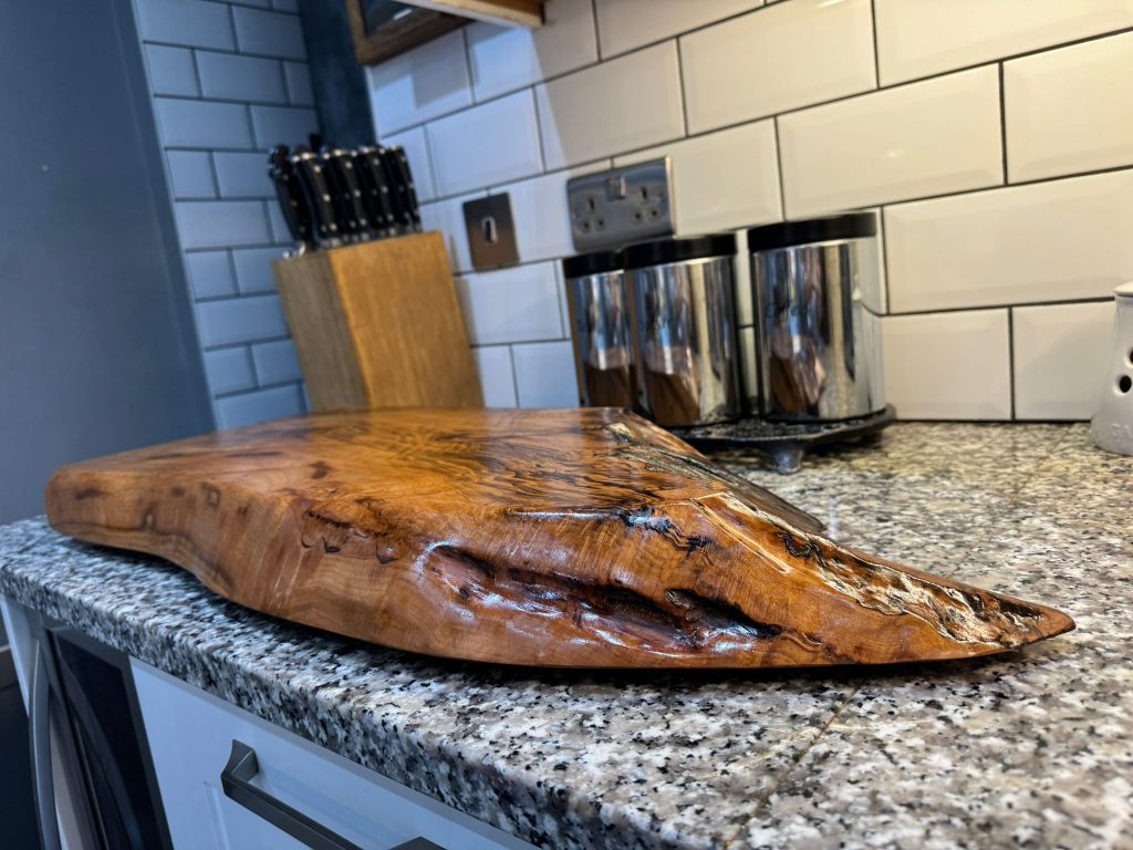  A sizable wooden block placed on a countertop, highlighting its rustic appearance and smooth surface